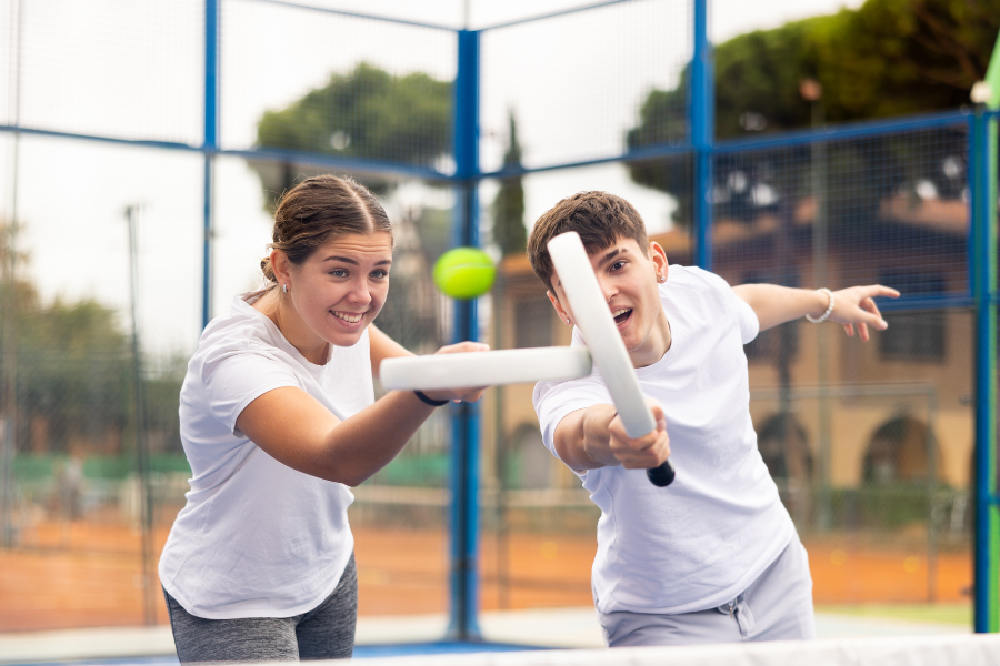 a man and woman playing padel